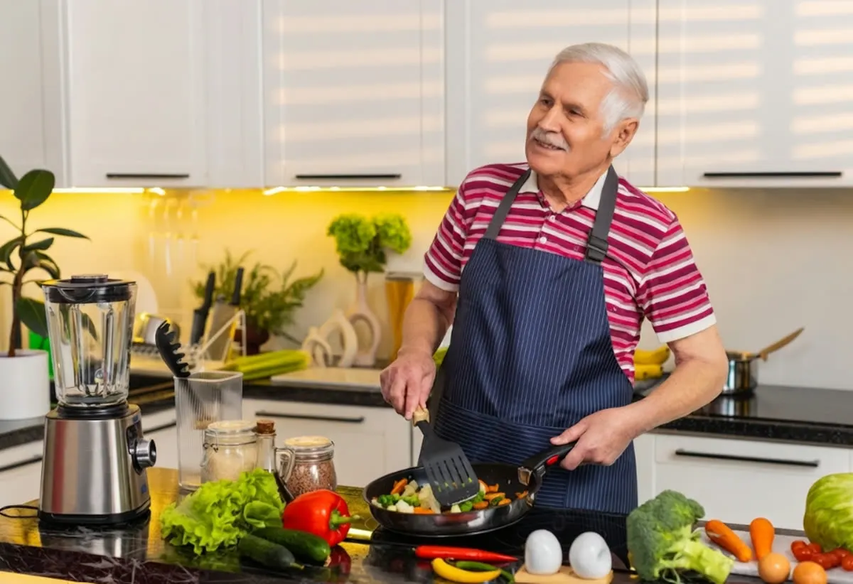 A senior man in his kitchen, part of an unhurried in-home consultation
